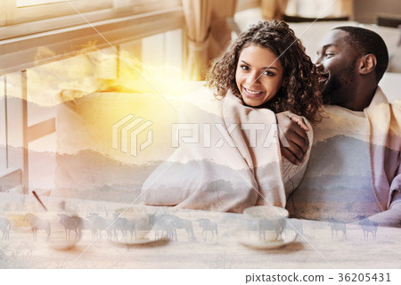Cheerful couple sitting close to each other 36205431