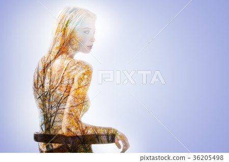 Pleasant young woman thinking about autumn Pleasant young woman thinking about autumn 36205498