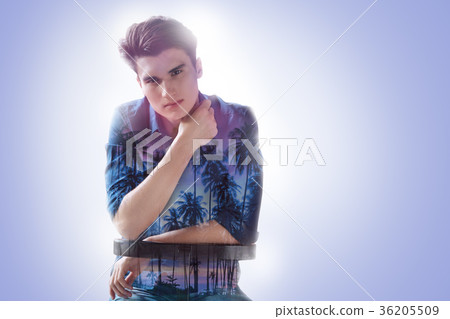 Serious young man dreaming about the beach Serious young man dreaming about the beach 36205509