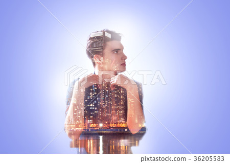 Nice thoughtful man sitting against blue Nice thoughtful man sitting against blue 36205583