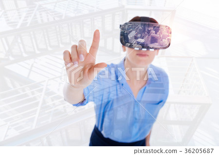 Serious attractive woman concentrated on VR 36205687