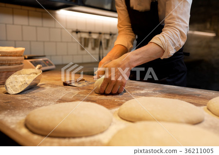 chef or baker cooking dough at bakery 36211005