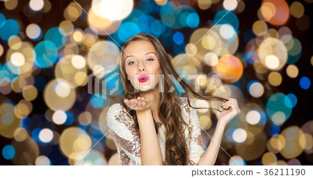 happy woman sending air kiss over party lights happy woman sending air kiss over party lights 36211190