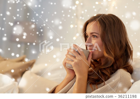 happy woman with cup of coffee in bed at home happy woman with cup of coffee in bed at home 36211198
