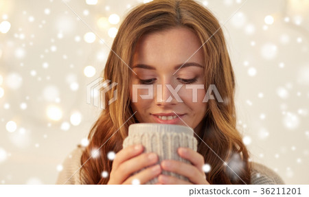 close up of woman with tea or coffee cup at home close up of woman with tea or coffee cup at home 36211201