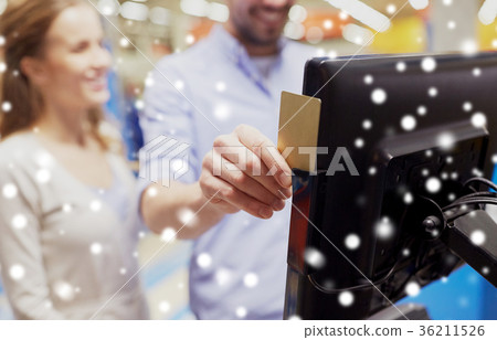 couple with customer card at store self-checkout couple with customer card at store self-checkout 36211526