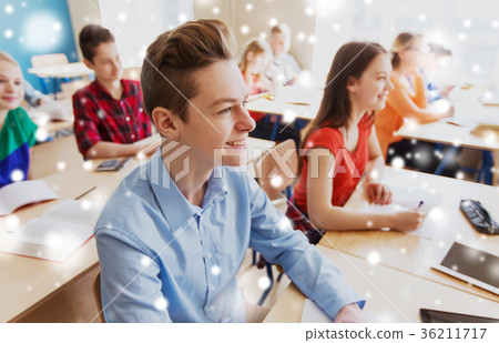 group of students with notebooks at school lesson 36211717