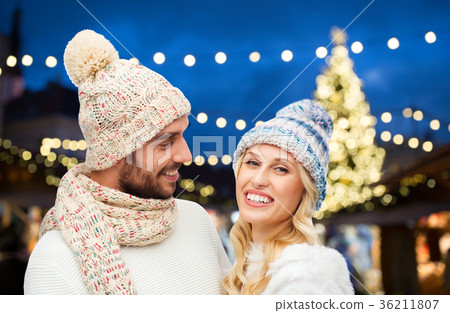 happy couple over christmas tree lights 36211807