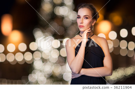 woman wearing jewelry over christmas lights woman wearing jewelry over christmas lights 36211904
