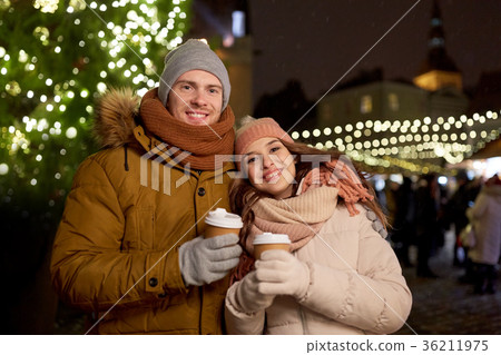 happy young couple with coffee at christmas market happy young couple with coffee at christmas market 36211975