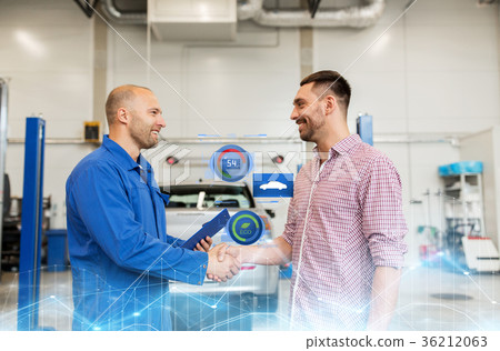 auto mechanic and man shaking hands at car shop 36212063