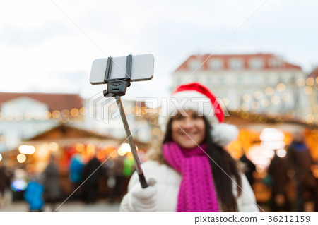woman taking selfie with smartphone at christmas 36212159