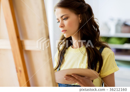 student girl with easel painting at art school student girl with easel painting at art school 36212160