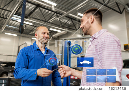 auto mechanic giving key to man at car shop auto mechanic giving key to man at car shop 36212686