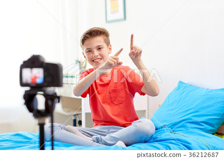 happy boy with camera recording video at home happy boy with camera recording video at home 36212687