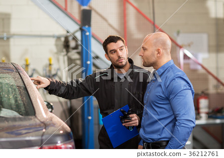 auto mechanic and customer at car shop 36212761