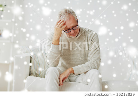 senior man suffering from headache at home 36212829