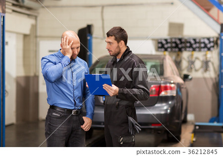 auto mechanic and customer at car shop 36212845