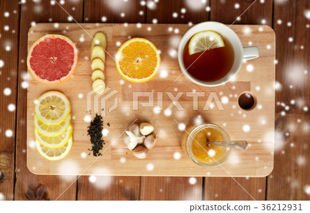 ginger tea with honey, citrus and garlic on wood ginger tea with honey, citrus and garlic on wood 36212931