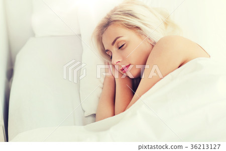young woman sleeping in bed at home bedroom 36213127