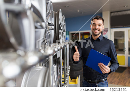 auto business owner and wheel rims at car service 36213361