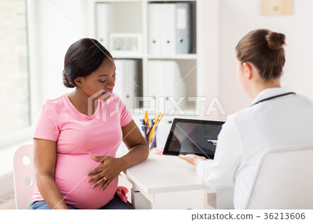 doctor with tablet pc and pregnant woman at clinic 36213606