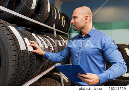 auto business owner and wheel tires at car service 36213719