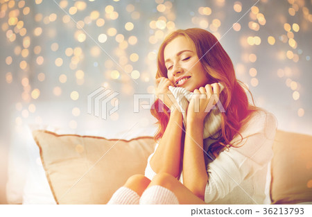 happy young woman in warm pullover at home 36213793