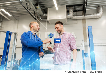 auto mechanic giving key to man at car shop auto mechanic giving key to man at car shop 36213808