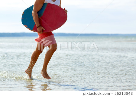 young man with skimboard on summer beach young man with skimboard on summer beach 36213848