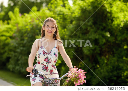 happy woman riding fixie bicycle in summer park 36214053
