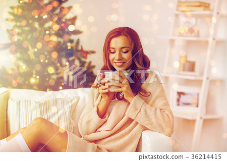 happy woman with cup of tea at home for christmas 36214415