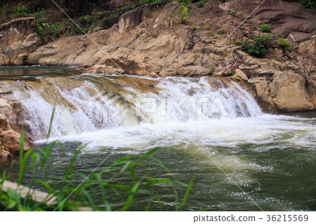 Foamy Waterfall in Pond near Grass in Tropics Foamy Waterfall in Pond near Grass in Tropics 36215569