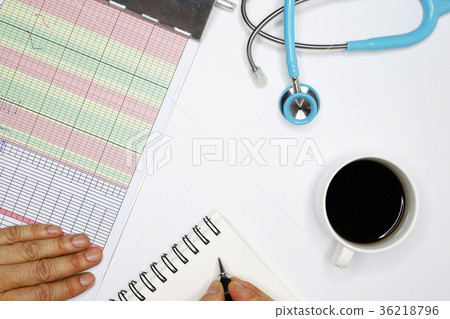 a doctor taking note of patient's condition 36218796