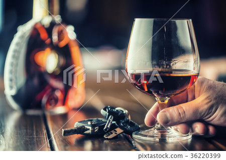 Cup cognac or brandy hand man the keys to the car. 36220399