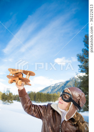 Happy child playing with toy airplane 36222613