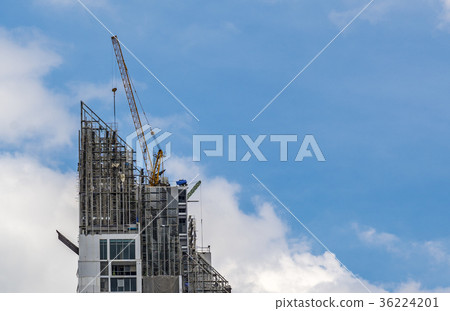 Crane working on top building 36224201