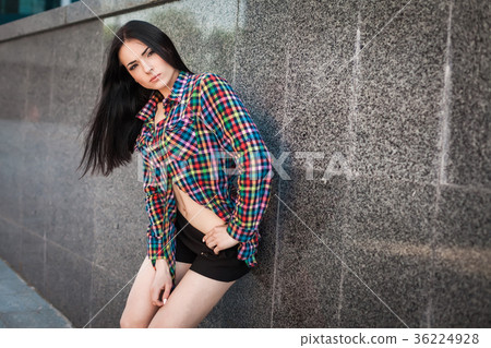 sexy hipster girl leaning against the wall in the 36224928
