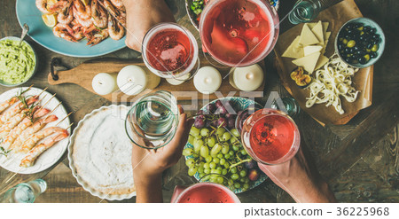 Flat-lay of friends hands eating and drinking Flat-lay of friends hands eating and drinking 36225968