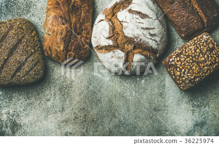 Top view of rustic bread loaves over grey Top view of rustic bread loaves over grey 36225974