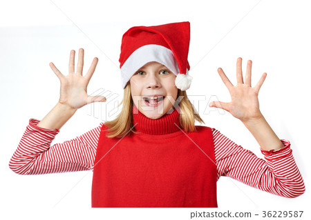 Beautiful girl in Santa hat showing her palms 36229587