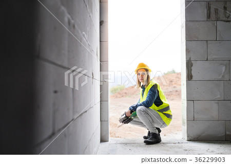 Young woman worker on the construction site. 36229903