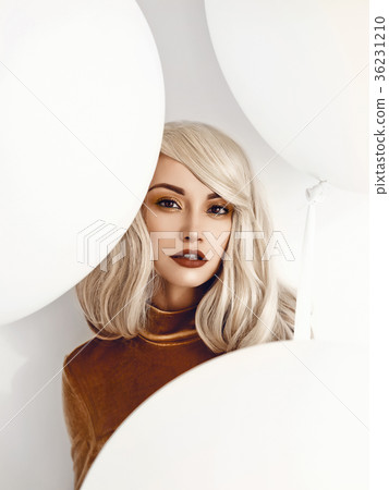 Beautiful woman with three white big balloons 36231210