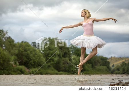 Ballerina jumping above river 36231524