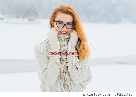 Beautiful smiling red head woman with glasses is Beautiful smiling red head woman with glasses is 36231783
