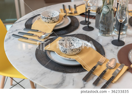 table set on round table with yellow chair table set on round table with yellow chair 36233835