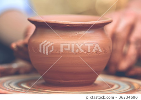 Potter making ceramic pot on the pottery wheel Potter making ceramic pot on the pottery wheel 36234690