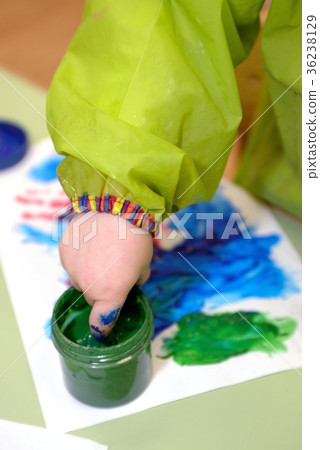 Imprint of watercolor paint on a child's hand 36238129