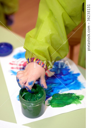 Imprint of watercolor paint on a child's hand 36238131