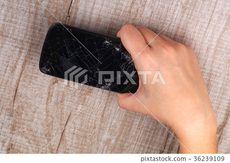 Smartphone with a broken screen in the girl's hand Smartphone with a broken screen in the girl's hand 36239109